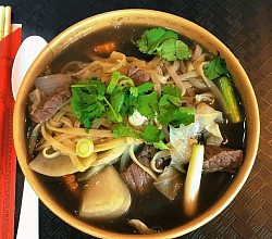 Beef Noodle Soup (Kuay Tiew Neua)  A comforting Thai beef broth with tender sliced beef, rice noodles, bean sprouts, spring onions, and aromatic herbs.