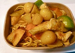 Rich, creamy Massaman curry with tender chicken, soft potatoes, and peppers in a warm, aromatic sauce.