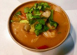 Hot and sour Tom Yum Goong with juicy prawns, mushrooms, herbs, and a fragrant chilli, lime broth.
